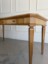 Load image into Gallery viewer, This Hickory White Home Office Desk is an open-box showroom sample with clean lines, tailored proportions, and a warm wood finish that brings a refined, classic presence to a workspace. The long rectangular top offers generous room for a laptop, writing materials, and everyday office essentials, while the slender fluted legs keep the silhouette light and elegant. Good Bones Furniture
