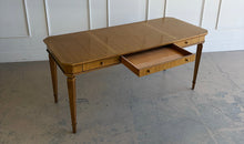 Load image into Gallery viewer, This Hickory White Home Office Desk is an open-box showroom sample with clean lines, tailored proportions, and a warm wood finish that brings a refined, classic presence to a workspace. The long rectangular top offers generous room for a laptop, writing materials, and everyday office essentials, while the slender fluted legs keep the silhouette light and elegant. Good Bones Furniture
