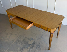 Load image into Gallery viewer, This Hickory White Home Office Desk is an open-box showroom sample with clean lines, tailored proportions, and a warm wood finish that brings a refined, classic presence to a workspace. The long rectangular top offers generous room for a laptop, writing materials, and everyday office essentials, while the slender fluted legs keep the silhouette light and elegant. Good Bones Furniture
