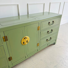 Load image into Gallery viewer, Green sideboard with gold accents against a white wall.
