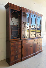 Load image into Gallery viewer, The Jonathan Charles Mahogany Breakfront Secretary Bookcase is a statement piece that combines the functionality of a library cabinet, secretary desk, display cabinet, and storage credenza in a single heirloom-quality design. Crafted with richly figured flame mahogany veneers, the cabinet showcases the level of craftsmanship that has made Jonathan Charles a respected name among collectors, designers, and luxury furniture retailers. Good Bones Furniture
