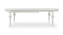 Load image into Gallery viewer, Butterfly oval extension dining table in white mahogany shown extended, featuring sculpted apron and turned legs, Kraton dining table by Good Bones Furniture in Raleigh, NC
