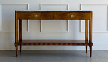 Load image into Gallery viewer, The Lipton 2 Drawer Console Table is a study in balance—combining classical detailing with a clean, tailored silhouette. Fluted legs, subtle carved accents, and a lower display shelf give the piece a refined, architectural presence, while the overall proportions keep it light and versatile. The drawer fronts are wrapped in richly figured cerejeira veneer. Good Bones Furniture
