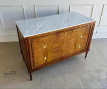 Load image into Gallery viewer, The Lipton Accent Chest is an exquisite blend of classic design and modern luxury. Crafted from mahogany solids with cerejeira and mahogany veneers, this piece showcases a stunning, highly figured grain pattern framed by elegant fluted corner details. The smooth white marble top or luxurious mahogany top adds a timeless sophistication and practical durability, making this chest as functional as it is beautiful. Good Bones Furniture
