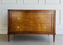 Load image into Gallery viewer, The Lipton Accent Chest is an exquisite blend of classic design and modern luxury. Crafted from mahogany solids with cerejeira and mahogany veneers, this piece showcases a stunning, highly figured grain pattern framed by elegant fluted corner details. The smooth white marble top or luxurious mahogany top adds a timeless sophistication and practical durability, making this chest as functional as it is beautiful. Good Bones Furniture
