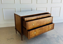 Load image into Gallery viewer, The Lipton Accent Chest is an exquisite blend of classic design and modern luxury. Crafted from mahogany solids with cerejeira and mahogany veneers, this piece showcases a stunning, highly figured grain pattern framed by elegant fluted corner details. The smooth white marble top or luxurious mahogany top adds a timeless sophistication and practical durability, making this chest as functional as it is beautiful. Good Bones Furniture
