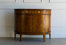 Load image into Gallery viewer, The Lipton Demilune Cabinet is a refined storage piece with a softly curved, architectural silhouette. Crafted from mahogany solids with cerejeira veneers, it showcases a flowing, bookmatched grain pattern across the rounded front for a warm, elevated look. Good Bones Furniture
