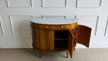 Load image into Gallery viewer, The Lipton Demilune Cabinet is a refined storage piece with a softly curved, architectural silhouette. Crafted from mahogany solids with cerejeira veneers, it showcases a flowing, bookmatched grain pattern across the rounded front for a warm, elevated look. Good Bones Furniture
