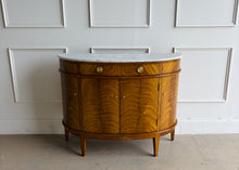 Load image into Gallery viewer, The Lipton Demilune Cabinet is a refined storage piece with a softly curved, architectural silhouette. Crafted from mahogany solids with cerejeira veneers, it showcases a flowing, bookmatched grain pattern across the rounded front for a warm, elevated look. Good Bones Furniture
