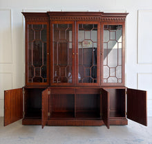 Load image into Gallery viewer, This Georgian-style breakfront china cabinet by Maitland Smith showcases the impeccable construction and richly figured mahogany the maker is known for. The upper cabinet features an illuminated interior behind glass-paneled doors, with adjustable glass shelves that beautifully display china, books, or collected objects. The top is made in three separate sections for easier transport and installation. Good Bones Furniture
