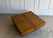 Load image into Gallery viewer, The Margo Square Coffee Table makes an impact through proportion, material, and simplicity. Its low, architectural profile gives it a grounded presence, while the richly figured veneer brings warmth and movement across the broad square top. Set on a recessed base, the silhouette feels clean and modern with a subtle floating effect. Good Bones Furniture
