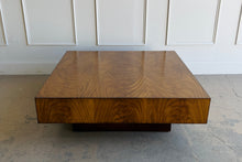 Load image into Gallery viewer, The Margo Square Coffee Table makes an impact through proportion, material, and simplicity. Its low, architectural profile gives it a grounded presence, while the richly figured veneer brings warmth and movement across the broad square top. Set on a recessed base, the silhouette feels clean and modern with a subtle floating effect. Good Bones Furniture
