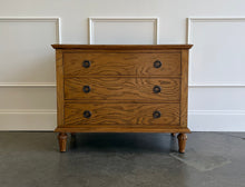 Load image into Gallery viewer, The Milano Large Nightstand is a harmonious blend of thoughtful craftsmanship and versatile style. Handcrafted from solid mahogany and burled ash veneer, it offers three roomy drawers fitted with smooth, self closing glides for effortless access to your evening essentials. Solid brass hardware punctuates the design. Good Bones Furniture
