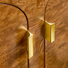 Load image into Gallery viewer, The Modern History Arches Credenza is a striking statement piece defined by rich material and architectural form. Wrapped in dramatic Ashe burl veneer, the surface reveals intricate swirling grain patterns that create depth and visual movement across the entire façade. A sequence of softly arched doors gives the cabinet its signature rhythm, adding sculptural interest while maintaining a clean, tailored silhouette. Good Bones Furniture
