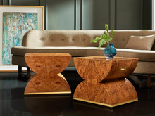 Load image into Gallery viewer, The Modern History Geometric Stool is a striking blend of timeless craftsmanship and contemporary design. Featuring the exquisite Olive Ashe burl veneer, this stool showcases the natural beauty of its richly patterned wood grain, creating a warm and elegant statement piece. Brass accents add a touch of glamour, enhancing the geometric form with their sleek, polished finish.
