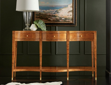 Load image into Gallery viewer, The Modern History Serpentine Console in Olive Ashe combines graceful contours and exquisite materials into a statement piece that enriches any interior. Its gently curved front showcases Olive Ashe Burl Veneer, a richly patterned wood surface that reveals intricate swirls and subtle tonal variations. The warm, natural beauty of this veneer is further enhanced by polished brass accents, providing a sophisticated contrast and a touch of timeless glamour.
