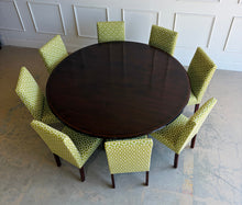 Load image into Gallery viewer, Designed by Mr. &amp; Mrs. Howard for Sherrill Furniture, this elegant 72" round dining table combines timeless Georgian-inspired styling with exceptional craftsmanship. The rich mahogany finish highlights the beautiful veneer pattern, while the graceful four-splay pedestal base is accented with brass toe caps and casters. Good Bones Furniture
