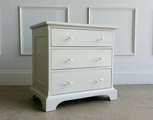 Load image into Gallery viewer, A beautifully refinished Newport Cabinet Company nightstand professionally lacquered in Benjamin Moore Natural Cream and updated with elegant lucite and polished brass hardware. Three spacious drawers provide convenient bedside storage. Good Bones Furniture
