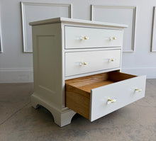 Load image into Gallery viewer, A beautifully refinished Newport Cabinet Company nightstand professionally lacquered in Benjamin Moore Natural Cream and updated with elegant lucite and polished brass hardware. Three spacious drawers provide convenient bedside storage. Good Bones Furniture
