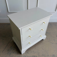 Load image into Gallery viewer, A beautifully refinished Newport Cabinet Company nightstand professionally lacquered in Benjamin Moore Natural Cream and updated with elegant lucite and polished brass hardware. Three spacious drawers provide convenient bedside storage. Good Bones Furniture
