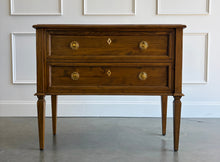 Load image into Gallery viewer, The Phillips Scott Franklin Chest pairs classic proportions with practical storage and a light, elevated silhouette. Crafted from hardwood solids and veneers, it features two spacious drawers framed by traditional molding. Brass hardware and decorative key escutcheons add warmth, while the molded top and tall tapered legs complete its timeless design. Good Bones Furniture
