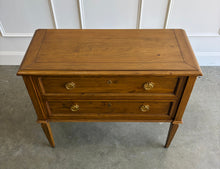 Load image into Gallery viewer, The Phillips Scott Franklin Chest pairs classic proportions with practical storage and a light, elevated silhouette. Crafted from hardwood solids and veneers, it features two spacious drawers framed by traditional molding. Brass hardware and decorative key escutcheons add warmth, while the molded top and tall tapered legs complete its timeless design. Good Bones Furniture
