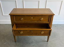 Load image into Gallery viewer, The Phillips Scott Franklin Chest pairs classic proportions with practical storage and a light, elevated silhouette. Crafted from hardwood solids and veneers, it features two spacious drawers framed by traditional molding. Brass hardware and decorative key escutcheons add warmth, while the molded top and tall tapered legs complete its timeless design. Good Bones Furniture
