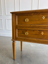 Load image into Gallery viewer, The Phillips Scott Franklin Chest pairs classic proportions with practical storage and a light, elevated silhouette. Crafted from hardwood solids and veneers, it features two spacious drawers framed by traditional molding. Brass hardware and decorative key escutcheons add warmth, while the molded top and tall tapered legs complete its timeless design. Good Bones Furniture
