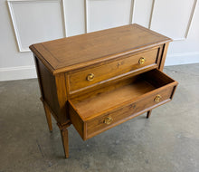 Load image into Gallery viewer, The Phillips Scott Franklin Chest pairs classic proportions with practical storage and a light, elevated silhouette. Crafted from hardwood solids and veneers, it features two spacious drawers framed by traditional molding. Brass hardware and decorative key escutcheons add warmth, while the molded top and tall tapered legs complete its timeless design. Good Bones Furniture
