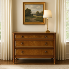 Load image into Gallery viewer, Elegant and effortlessly functional, the Riley Mahogany Chest pairs classic proportions with luxe details. A cerejeira (Brazilian oak) veneer creates a striking feathered grain across the drawer fronts, framed by subtle gold trim that’s echoed on the turned feet. Finished in a warm mahogany tone with mahogany or marble top and fitted with antique brass ring pulls, Riley brings tailored sophistication to bedrooms, entryways, or living spaces while offering generous, everyday storage. Good Bones Furniture
