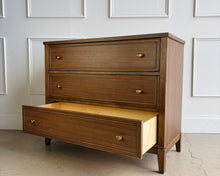 Load image into Gallery viewer, The Sherrill Occasional 3 Drawer Single Dresser offers clean transitional styling with refined materials and balanced proportions. Crafted from maple solids and quartered walnut veneers, this piece showcases subtle linear grain movement enhanced by the warm Cashew finish. Good Bones Furniture
