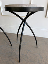 Load image into Gallery viewer, This pair of Studio|A accent tables blends sculptural ironwork with natural stone in a way that feels both organic and architectural. Featuring hand-worked forged iron bases with airy tripod silhouettes, the tables have a visually light presence despite the substantial stone tops. Good Bones Furniture
