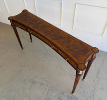 Load image into Gallery viewer, Overhead perspective of the Theodore Alexander Grandinson console showing its elegant concave profile, flame walnut veneer, and classic Regency-inspired form
