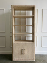 Load image into Gallery viewer, The Horizon Etagere by Theodore Alexander combines generous display space with a light, contemporary silhouette. Crafted from oak in a pale Day finish, its softly rounded frame and finely reeded details introduce texture while preserving the collection’s clean lines. Multiple open shelves provide ample room for books, art, and collected objects, while the two-door cabinet below offers convenient concealed storage. Good Bones Furniture
