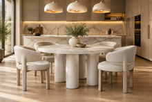 Load image into Gallery viewer, The Maxwell Round Dining Table by Theodore Alexander combines natural oak grain with distinctive shagreen texture and an architectural silhouette. Crafted from oak wood and oak veneers, the generous round top is finished in pale Cashmere, allowing its organic grain to remain visible. Four cylindrical supports feature a subtle shagreen surface in a tonal Dove finish. Good Bones Furniture
