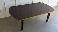 Load image into Gallery viewer, Theodore Alexander Sebastiano Dining Table pairs a historic silhouette with a modern, tailored edge. Its gently curved rectangular top is framed by a brass-bound apron that gives the piece a crisp, architectural presence, while slatted baluster legs outlined in gilt add depth and refinement. Open box showroom sample. Good Bones Furniture
