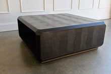 Load image into Gallery viewer, The Spencer St. James Square Cocktail Table by Theodore Alexander combines bold contemporary form with richly tactile materials. Crafted from oak wood and crocodile-embossed leather, its substantial square silhouette features clipped corners that soften the strong architectural lines. Good Bones Furniture
