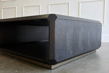 Load image into Gallery viewer, The Spencer St. James Square Cocktail Table by Theodore Alexander combines bold contemporary form with richly tactile materials. Crafted from oak wood and crocodile-embossed leather, its substantial square silhouette features clipped corners that soften the strong architectural lines. Good Bones Furniture

