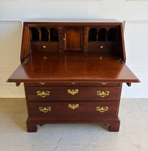 Load image into Gallery viewer, This traditional Chippendale mahogany secretary combines classic American craftsmanship with everyday functionality in a compact footprint. Crafted in rich mahogany with a warm satin finish, it features a slant-front writing surface that opens to reveal a thoughtfully organized interior complete with pigeonholes, two small drawers, and a center cabinet for storing stationery and essentials. Good Bones Furniture
