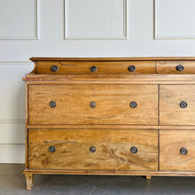 Load image into Gallery viewer, Built from solid mango wood, the Valencia dresser mixes timeless European lines with a relaxed, hand-finished patina. A stepped gallery crowns the case, while framed drawer fronts and reeded, tapered feet give the piece architectural presence. At 72" wide with six generous drawers, it brings warm, natural character and serious storage to the primary bedroom, guest suite, or sophisticated entry.
