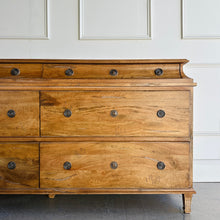 Load image into Gallery viewer, Built from solid mango wood, the Valencia dresser mixes timeless European lines with a relaxed, hand-finished patina. A stepped gallery crowns the case, while framed drawer fronts and reeded, tapered feet give the piece architectural presence. At 72" wide with six generous drawers, it brings warm, natural character and serious storage to the primary bedroom, guest suite, or sophisticated entry.
