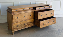 Load image into Gallery viewer, Built from solid mango wood, the Valencia dresser mixes timeless European lines with a relaxed, hand-finished patina. A stepped gallery crowns the case, while framed drawer fronts and reeded, tapered feet give the piece architectural presence. At 72" wide with six generous drawers, it brings warm, natural character and serious storage to the primary bedroom, guest suite, or sophisticated entry.
