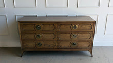 Load image into Gallery viewer, This handsome six-drawer dresser by Vanguard Furniture blends tailored lines with refined transitional styling. Crafted with beautifully grained oak veneers, it features sculpted drawer fronts, oversized antiqued brass ring pulls, and elegantly tapered legs that give the piece a sophisticated presence. Good Bones Furniture
