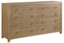 Load image into Gallery viewer, The Ventura Dresser by Modern History offers a refined balance of texture, craftsmanship, and understated luxury. Wrapped in oak random veneer, the surface highlights the natural variation of the wood grain, creating subtle depth and visual movement across the broad drawer fronts. The warm oak tone pairs beautifully with polished solid brass ring pulls and matching escutcheons, lending the piece a timeless, tailored character. Good Bones Furniture
