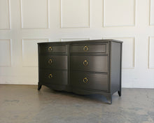 Load image into Gallery viewer, Front angled view of a refinished vintage six drawer dresser in Sherwin Williams Urbane Bronze with brass ring hardware, offering generous storage and timeless design by Good Bones Furniture
