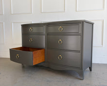 Load image into Gallery viewer, Refinished vintage six drawer dresser in Sherwin Williams Urbane Bronze with an open drawer highlighting interior wood tones and in-house refinishing quality by Good Bones Furniture.
