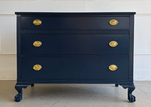 Load image into Gallery viewer, Classic craftsmanship meets a bold designer finish in this vintage ball and claw chest, professionally lacquered in Benjamin Moore In the Navy. The rich navy finish highlights the elegant fluted corner details, carved ball and claw feet, and decorative geometric molding across the upper drawer, while new solid brass Hepplewhite drawer pulls add a timeless finishing touch. Good Bones Furniture
