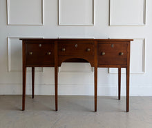 Load image into Gallery viewer, Antique bench made cherry sideboard with three drawers and tapered legs, shown in a bright white paneled room, featuring a clean architectural silhouette and warm natural wood finish. Good Bones Furniture
