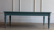 Load image into Gallery viewer, This vintage coffee table pairs classic architectural details with a fresh, colorful finish. Professionally lacquered in Sherwin-Williams Moody Blue, it features a rectangular top, subtly molded apron, carved corner accents, and tapered legs with recessed panel detailing.  Good Bones Furniture
