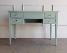 Load image into Gallery viewer, This vintage Craftique vanity has been professionally refinished in a custom light teal lacquer, giving the classic form a fresh, tailored look. Clean lines and tapered legs reflect the refined simplicity Craftique furniture is known for, while new lucite and brass hardware adds a subtle touch of modern glamour. Good Bones Furniture

